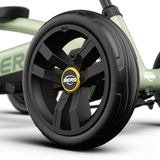 Close-up of the front wheel on the BERG Buzzy Green pedal go-kart with black tyre and BERG wheel badge