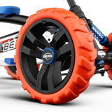 Close-up of orange wheel with black centre and BERG badge on BERG Buzzy Nitro pedal go-kart