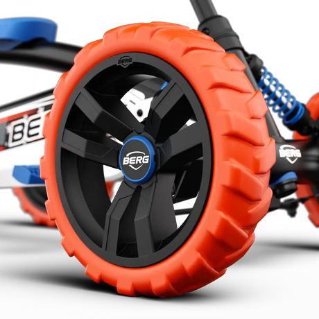 Close-up of orange wheel with black centre and BERG badge on BERG Buzzy Nitro pedal go-kart