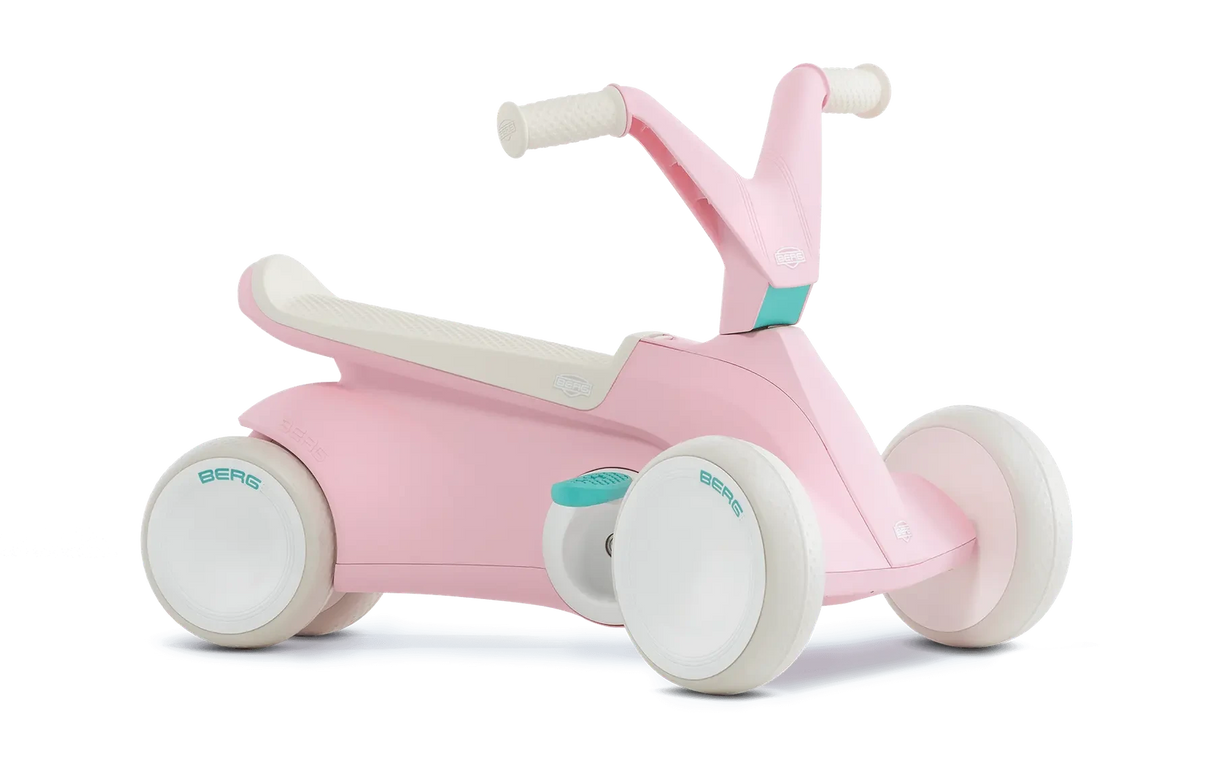 Angled view of pink BERG GO² ride-on with white wheels, white saddle and teal pedal details