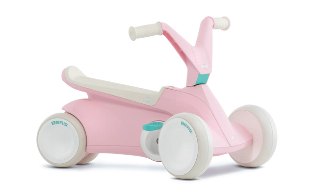 Angled view of pink BERG GO² ride-on with white wheels, white saddle and teal pedal details