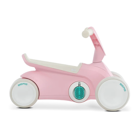 Side view of pink BERG GO² ride-on with white wheels, white saddle and teal pedal details