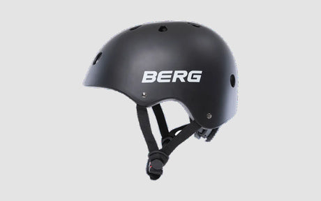 Black BERG helmet side angle with ventilation holes and adjustable strap visible – Ireland