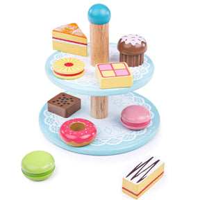 Two tier wooden cake stand with central wooden handle and pastel coloured wooden cakes arranged on both tiers