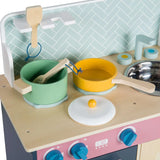 Wooden play cookware including a green pot, yellow pan, lids and utensils arranged on a wooden hob surface