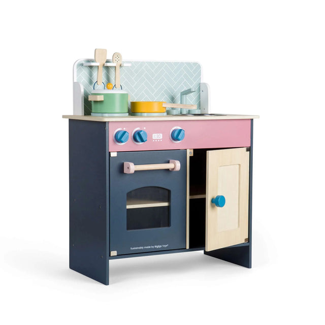 Wooden children’s play kitchen in navy, pink and natural wood with oven door, cupboard, knobs, sink and hob