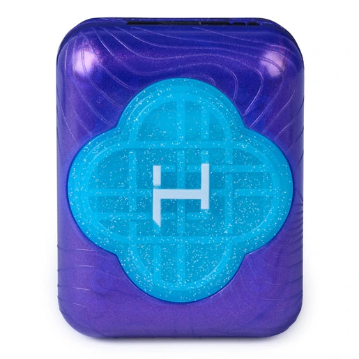Top view of the closed purple Bitzee KPop Demon Hunters pod, featuring a glittery turquoise Honmoon emblem with a white symbol in the centre.