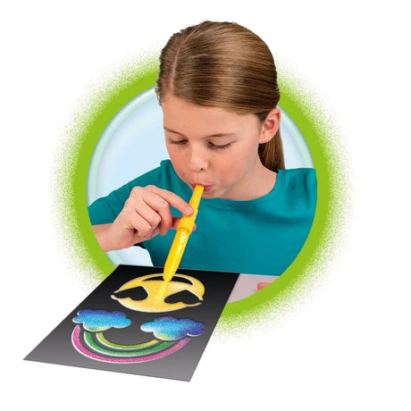 Child using a Blopen with a stencil to create a colourful sprayed picture