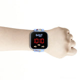 Bluey LED Digital Watch on a wrist with red LED time display and Bluey character printed strap