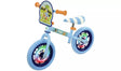 Bluey Light Up Balance Bike front angle view showing light blue frame, orange grip handles, striped blue and white saddle, Bluey character handlebar panel and lit wheel hubs