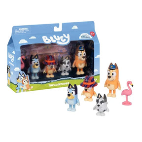 Bluey The Sleepover retail box displayed beside the four character figures Bluey, Bingo, Chilli and Muffin, with their episode costumes and pink flamingo accessory.