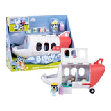 Bluey's Adventure Plane playset displayed beside its retail packaging, with the roof and side panel open to reveal the cabin, Pilot Bluey figure and suitcase.
