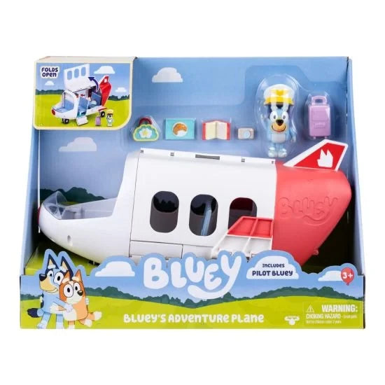 Bluey's Adventure Plane in retail packaging showing the white and red jet, Pilot Bluey figure, purple suitcase and travel accessories.