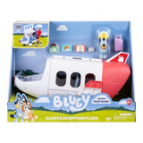 Bluey's Adventure Plane in retail packaging showing the white and red jet, Pilot Bluey figure, purple suitcase and travel accessories.