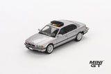 Mini GT James Bond BMW 750IL silver LHD model viewed from the front right showing the BMW kidney grille, headlights, bonnet and roof mounted unit