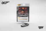 Mini GT BMW 750IL displayed in front of its Tomorrow Never Dies 007 blister packaging with film artwork and the silver model visible inside the pack