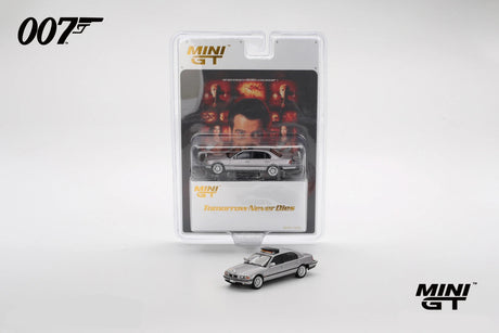 Mini GT BMW 750IL displayed in front of its Tomorrow Never Dies 007 blister packaging with film artwork and the silver model visible inside the pack