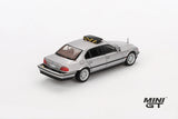 Mini GT James Bond Tomorrow Never Dies BMW 750IL silver LHD model viewed from the rear left showing the boot, rear lights, silver wheels and black roof unit