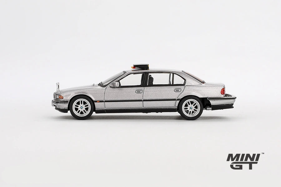Silver BMW 750IL from Tomorrow Never Dies in full left side profile showing the four door body, black window trim, silver wheels and roof mounted unit