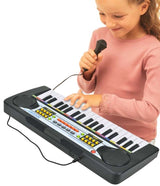 Child playing the Bontempi 37 Key Electronic Keyboard while holding the wired microphone