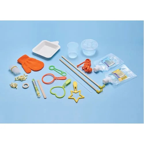 Full contents of Brainstorm Create Crazy Bubbles kit with bubble wands, gloves, rope, solution and tools on blue surface