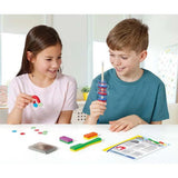 Brainstorm My First Magnet Kit being used by two children with ring magnets, horseshoe magnet and other kit pieces on the table