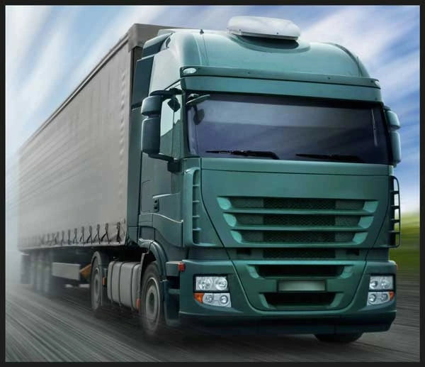 Brainstorm Tractor and Truck Torch and Projector image showing a green articulated lorry on the road