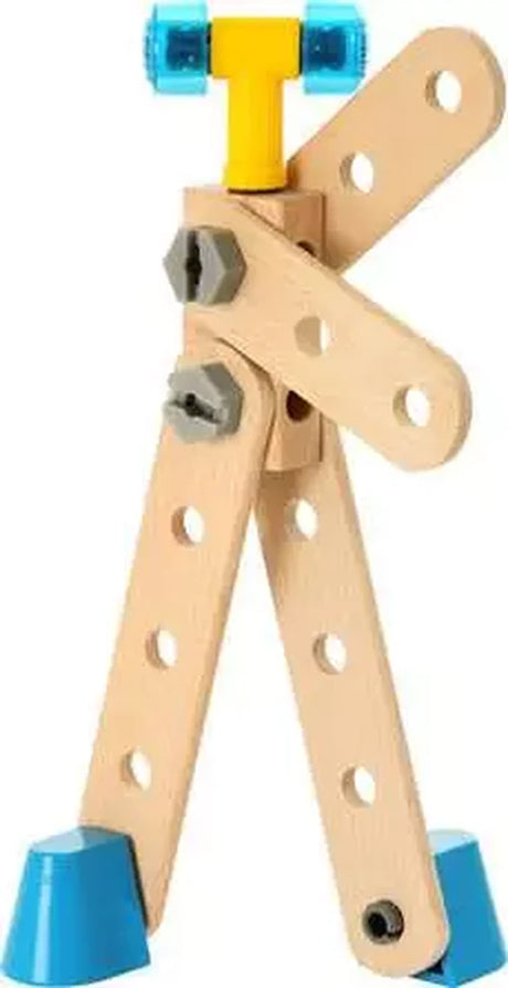 BRIO Builder construction assembled into a standing wooden figure with movable limbs, blue feet, grey bolts and a yellow component at the top.