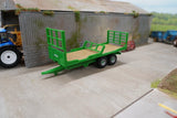 Britains 1:32 Flat Bed Trailer parked beside farm shed with green racks fitted