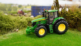 Britains John Deere 6M 240 farm toy tractor shown side on in a grass model farm layout