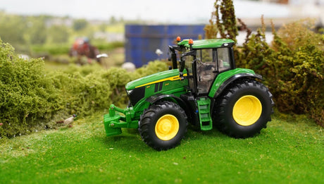 Britains John Deere 6M 240 farm toy tractor shown side on in a grass model farm layout