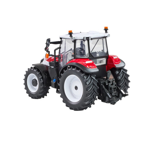 Britains Steyr 4120 Plus farm toy tractor shown from the rear side with grey cab, white wheels and tread tyres