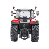 Britains Steyr 4120 Plus farm toy tractor shown from the rear with large black tread tyres and grey cab