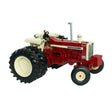Britains Case IH Farmall 1206 tractor model shown from front left angle with red bodywork, narrow front wheels, rear dual tyres, side engine detailing, exhaust stack and open operator seat