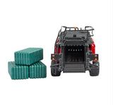 Rear view of Britains Case IH LB434R XL large baler model with open bale exit chamber, visible rear rollers, safety decals, twin wheels, and three green rectangular bales placed to the side on a white background