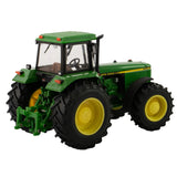 Britains John Deere 4955 tractor model shown from rear left angle with rear hitch assembly, cab interior visible through rear window, large rear tyres, smaller front tyres and roof warning lights