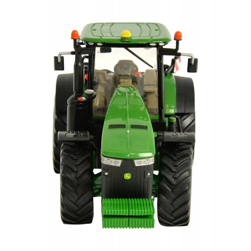 Front view of Britains John Deere 8400R 1:32 scale tractor model showing grille detail, headlights, front mounted weight block, wide tread front tyres, and enclosed cab on a white background