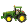 Britains John Deere 8400R tractor model shown in left side profile with green body, yellow wheels, enclosed cab, front weight attached, and John Deere decals on a white background