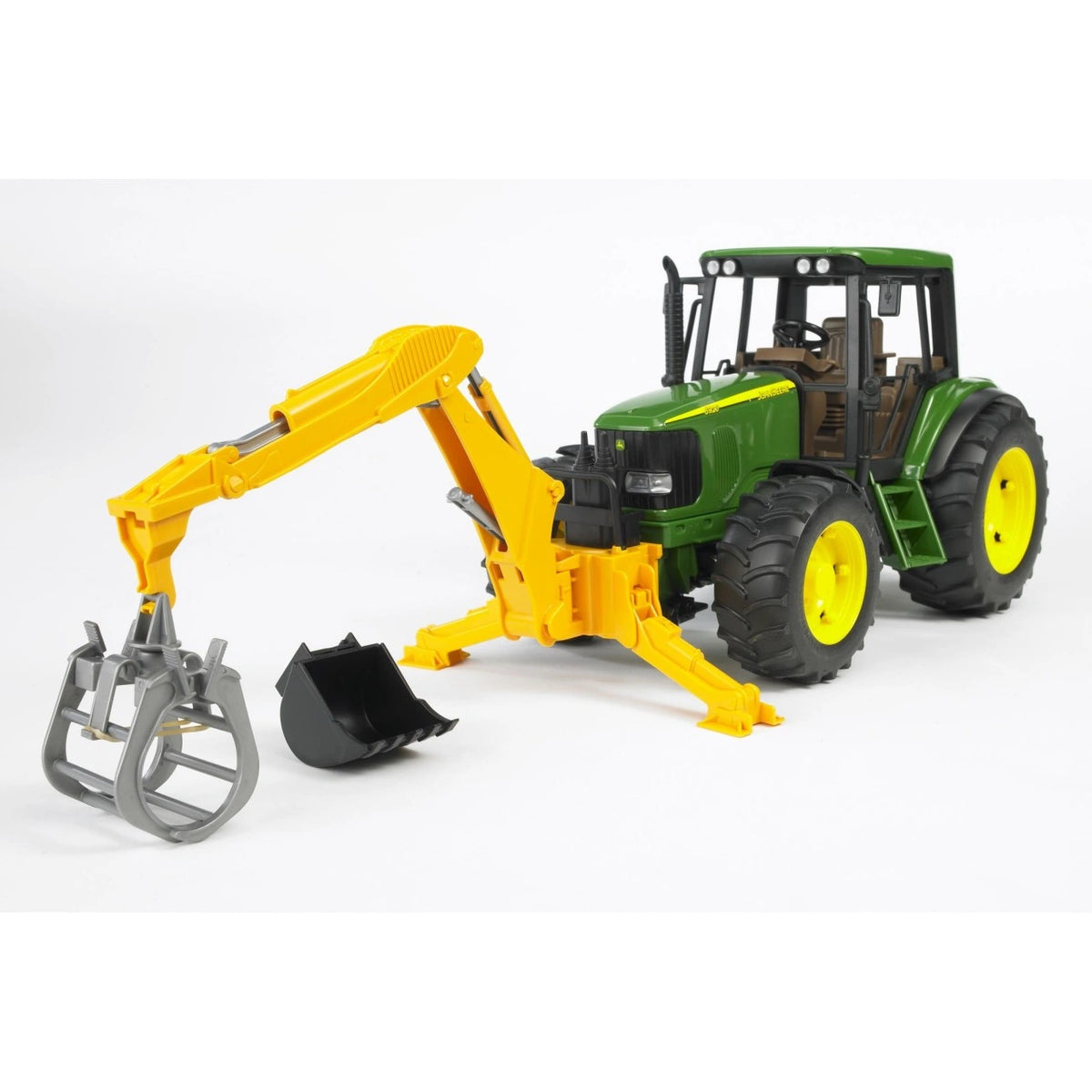 Bruder 02338 yellow rear hydraulic arm mounted on a green John Deere tractor, with grey grab fitted, black digging bucket beside it and support legs extended.