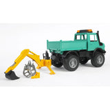 Bruder 02338 yellow hydraulic excavator attachment mounted behind a turquoise utility truck, with black digging bucket fitted, grey grab beside it and support legs extended.
