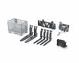 A set of Bruder accessories including a grey basket pallet, black pallet forks, black hay forks, a black adapter frame and a cable winch laid out on a white background.
