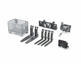 A set of Bruder accessories including a grey basket pallet, black pallet forks, black hay forks, a black adapter frame and a cable winch laid out on a white background.
