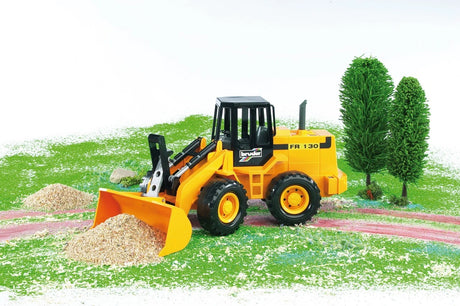 Bruder 1:16 articulated road loader FR 130 with the bucket pushing gravel in a play scene
