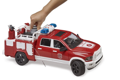Bruder 1:16 RAM 2500 fire engine truck with a hand pressing the grey tank cap on the rear bed