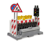 Bruder Traffic Safety Set with Traffic Light Accessories 62009 showing red and white barriers, warning posts and yellow construction lights stored in a grey holder with traffic lights and road signs