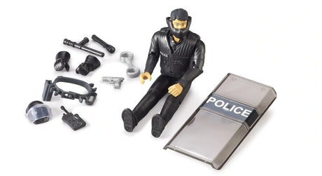 Bruder bworld Special Forces Police Officer 62151 seated beside a transparent POLICE shield, helmet visor, handcuffs, baton and removable police equipment.