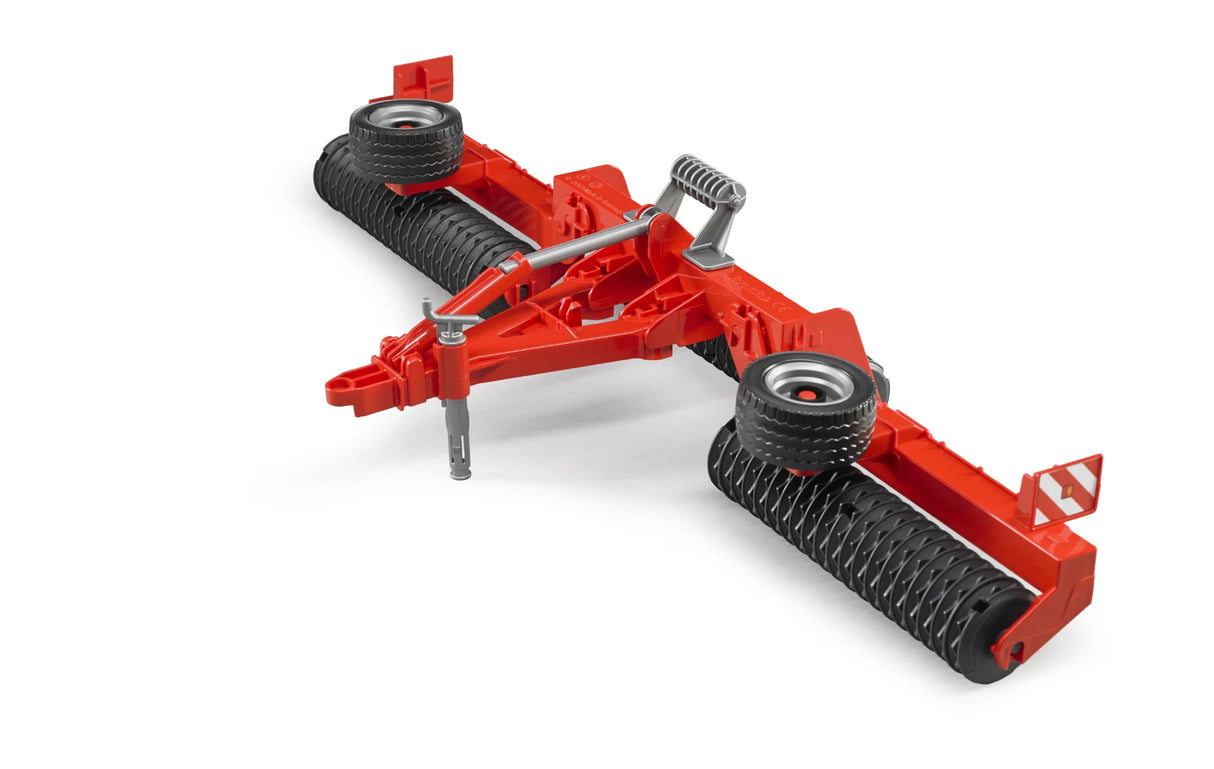 A red Bruder Cambridge Roller toy with black rollers and raised wheels shown on a plain white background.