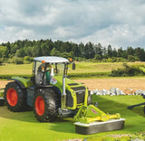 Bruder Claas Disco 3050 FC Plus mower attached to Claas tractor in realistic model farm field scene