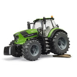 Bruder Deutz-Fahr 8280 TTV Tractor driving over field terrain with tread tyres and bright green body in Ireland