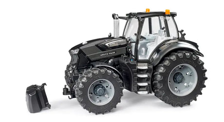 Bruder 1:16 Deutz-Fahr 8280 TTV Warrior black tractor, front left view with detached front weight beside it, showing large chunky tyres, silver rims and clear cab